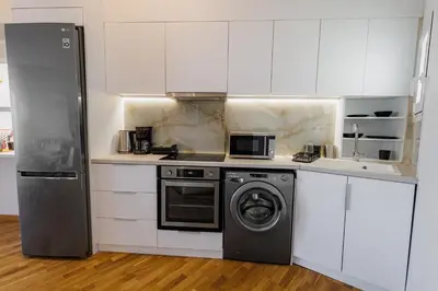 a kitchen with a washing machine and a washer at Penthouse Nest for 3 persons in Athens