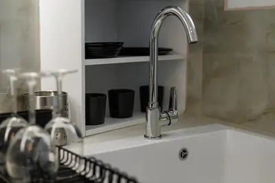 a kitchen sink with a faucet on a counter at Penthouse Nest for 3 persons in Athens