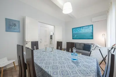 a dining room with a table and a couch at Peaceful and comfy 2BA in Athens heart in Athens
