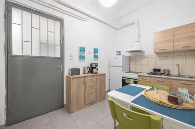 a kitchen with a table and yellow chairs at Peaceful and comfy 2BA in Athens heart in Athens