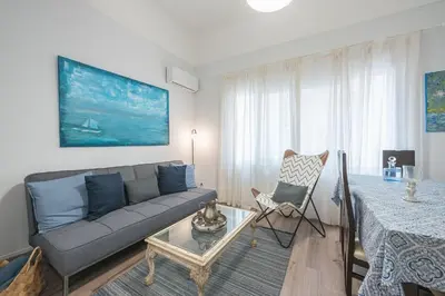 a living room with a couch and a table at Peaceful and comfy 2BA in Athens heart in Athens