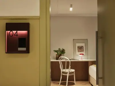 a room with a desk and a chair in a room at Presidential Suites, by Athens Stay in Athens