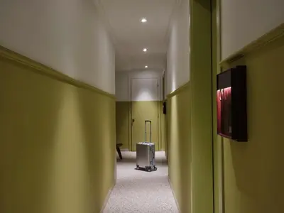 a hallway with a room with green walls and a suitcase at Presidential Suites, by Athens Stay in Athens