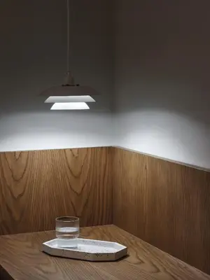 a room with a table with a glass and a light at Presidential Suites, by Athens Stay in Athens