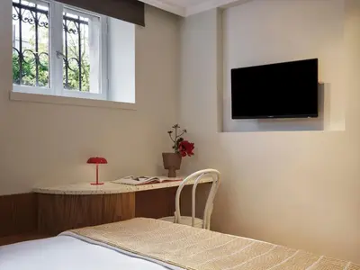 a bedroom with a bed and a tv on the wall at Presidential Suites, by Athens Stay in Athens