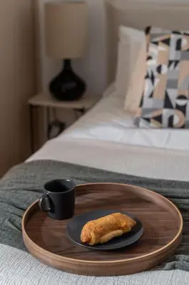 a plate of food and a cup of coffee on a bed at Renovated Gem near Pedion Areos Park & Museums in Athens