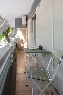 a room with a table and a table and chairs at Renovated Gem near Pedion Areos Park & Museums in Athens