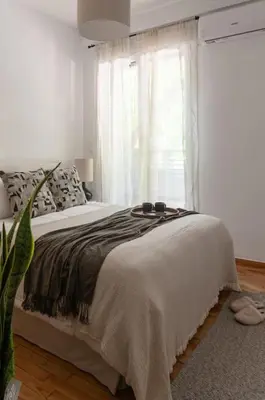 a bedroom with a large bed with a window at Renovated Gem near Pedion Areos Park & Museums in Athens