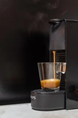 a black coffee maker sitting on a table at Renovated Gem near Pedion Areos Park & Museums in Athens