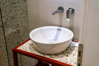 a white bowl sink sitting on a table in a bathroom at Arches Apartments in Athens