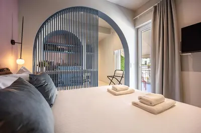 a bedroom with a bed with two towels on it at Arches Apartments in Athens