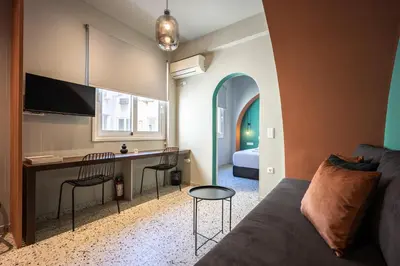 a living room with a couch and a table at Arches Apartments in Athens