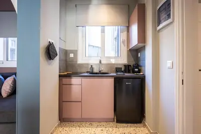 a small kitchen with a sink and a window at Arches Apartments in Athens