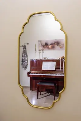 a mirror on a wall with a piano at Blue Ark Acropolis Signature Residence in Athens