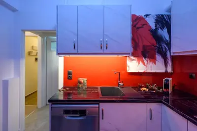 a kitchen with blue cabinets and a sink at Blue Ark Acropolis Signature Residence in Athens