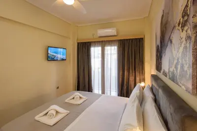 a hotel room with a bed with two towels on it at Blue Ark Acropolis Signature Residence in Athens