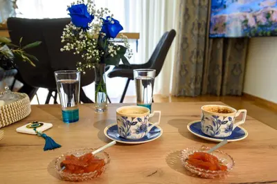 a table with two cups of coffee and saucers at Blue Ark Acropolis Signature Residence in Athens