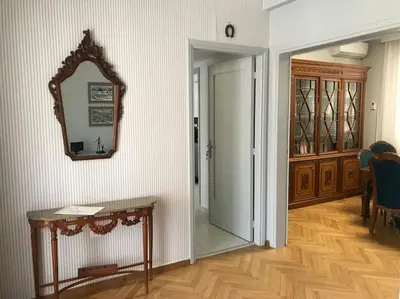 a hallway with a mirror on the wall and a table at Penthouse archeol musiem, 3BDR, big balcony, wifi 200 mbps fiber in Athens