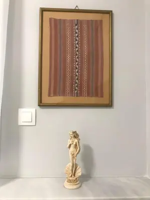 a picture hanging on a wall with a statue on a table at Penthouse archeol musiem, 3BDR, big balcony, wifi 200 mbps fiber in Athens