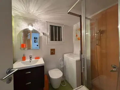 a bathroom with a toilet and a sink and a shower at Downtown Pagrati Modern Apartment in Athens