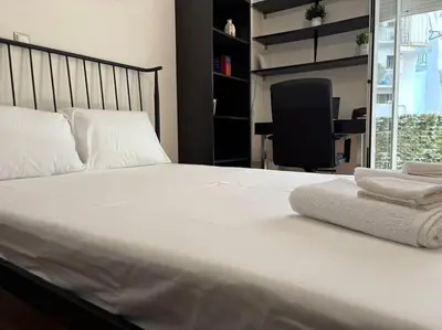 a bedroom with a bed with two towels on it at Downtown Pagrati Modern Apartment in Athens
