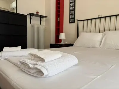 a bedroom with two white towels on a bed at Downtown Pagrati Modern Apartment in Athens