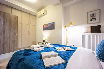 a bedroom with a blue bed with towels on it at Athens Luxury with Amazing View in Athens