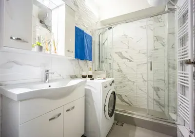 a white bathroom with a washing machine and a shower at Athens Luxury with Amazing View in Athens