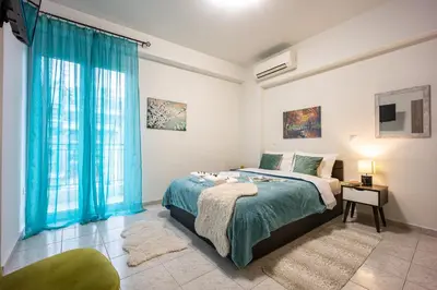 a bedroom with a bed with blue curtains at Athens Luxury with Amazing View in Athens