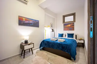 a bedroom with a blue bed and a night stand at Athens Luxury with Amazing View in Athens