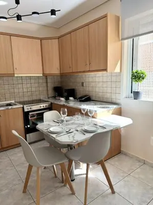 a kitchen with a table with wine glasses on it at Hera House Entire APT next to the Acropolis in Athens
