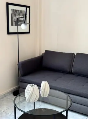 a living room with a couch and a glass table at Hera House Entire APT next to the Acropolis in Athens