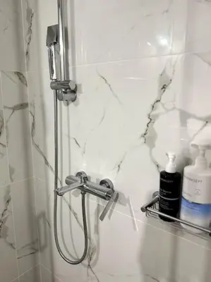 a shower in a bathroom with a shower head at Hera House Entire APT next to the Acropolis in Athens