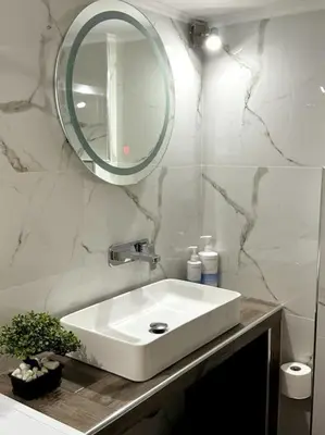 a bathroom with a white sink and a mirror at Hera House Entire APT next to the Acropolis in Athens