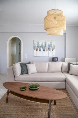 a living room with a couch and a coffee table at Luxury apt near the airport N2 in Spáta