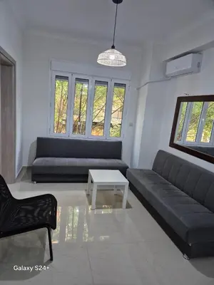 a living room with a couch and a table at Athens view in Athens