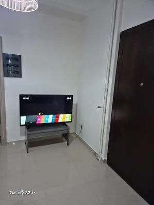 a flat screen tv sitting in a living room at Athens view in Athens