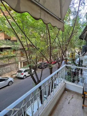 a balcony with a tree on a city street at Athens view in Athens