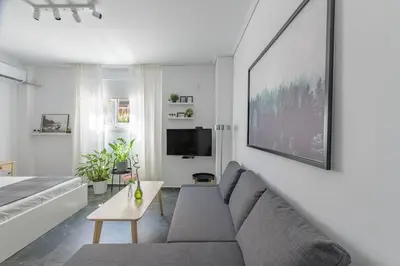 a living room with a couch and a tv at Central Studio in Athens lower Pangrati 650m Evangelismo Metro in Athens