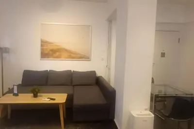 a living room with a couch and a table at Central Studio in Athens lower Pangrati 650m Evangelismo Metro in Athens