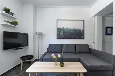 a living room with a couch and a table at Central Studio in Athens lower Pangrati 650m Evangelismo Metro in Athens