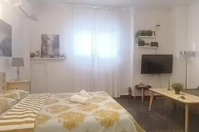 a bedroom with a bed and a desk and a television at Central Studio in Athens lower Pangrati 650m Evangelismo Metro in Athens
