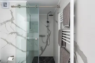 a bathroom with a shower and a glass shower stall at Central Studio in Athens lower Pangrati 650m Evangelismo Metro in Athens
