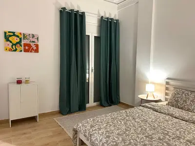 a bedroom with green curtains and a bed at Embassy studio in Athens