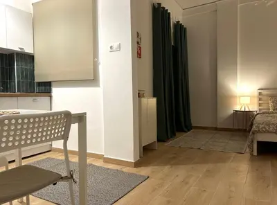 a living room with a bench and a table at Embassy studio in Athens