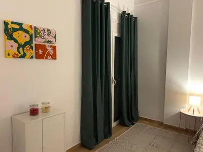 a room with green curtains next to a door at Embassy studio in Athens