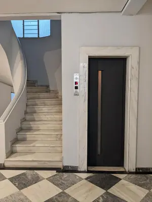a staircase with a black door in a building at Cozy Corner, One-Bedroom Flat in Athens