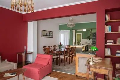 a living room with a table and a dining room at Casa al Museo in Athens