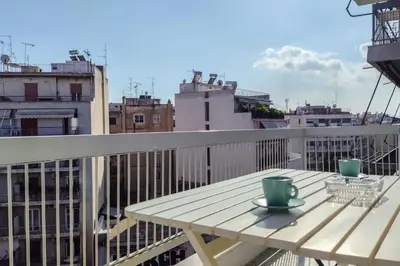 a wooden table with two cups on a balcony at Casa al Museo in Athens