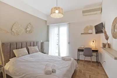 a bedroom with a bed with slippers on it at Pinelopi Spotless 2 BR Renovated Apt Athens Center in Athens